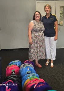 Maria Brown (right) and Fred D'Alauro deliver backpacks to North Jefferson Elementary